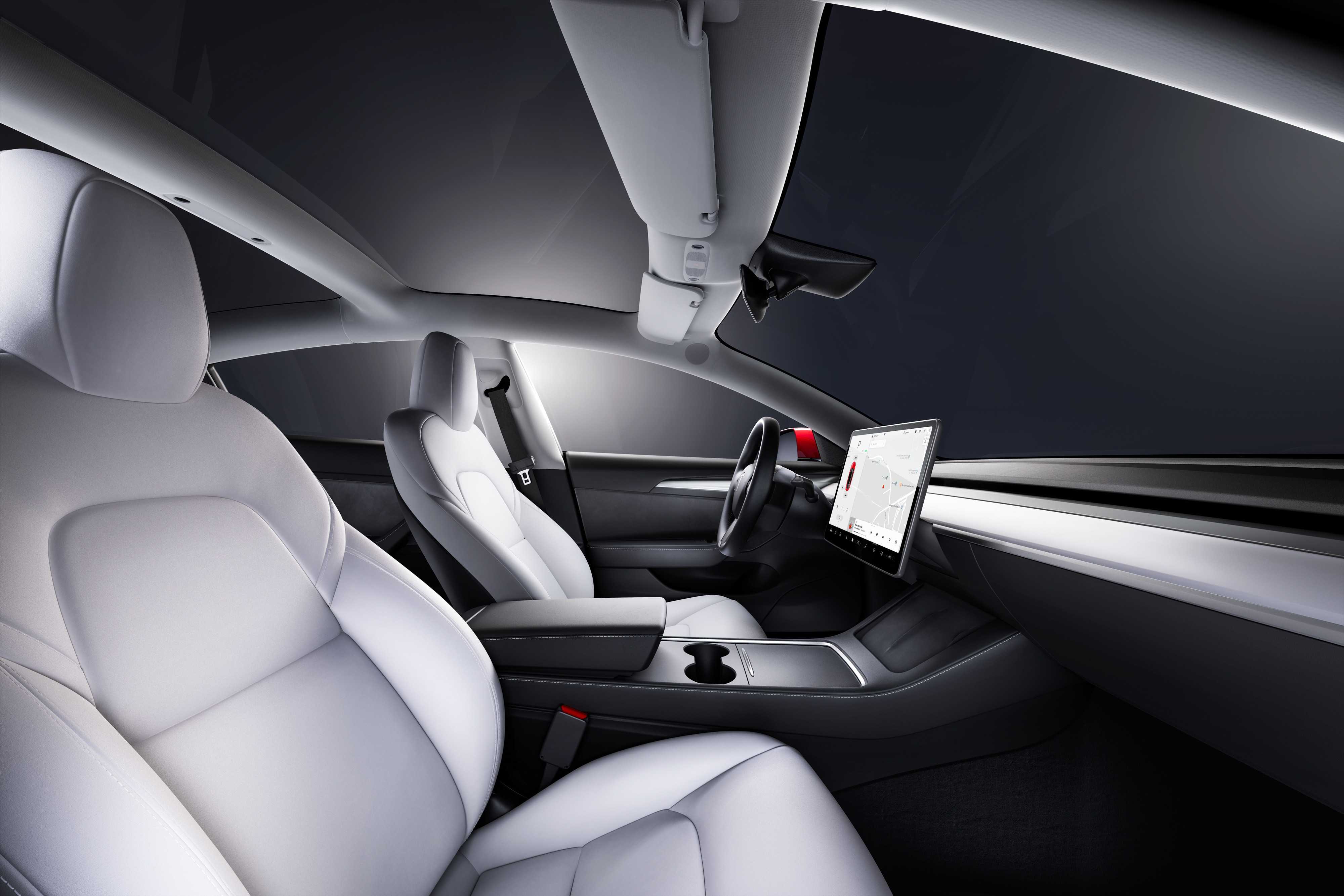 Interior of a modern car showing white leather seats, dashboard, steering wheel, and a large touchscreen display